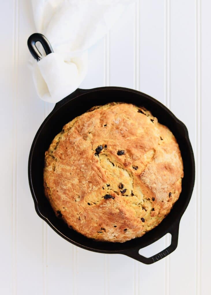 Irish Soda Bread is an easy quick bread. No yeast required! Buttermilk and baking soda help the bread rise. This recipe yields a bread that is dense, soft, and has a crispy, golden crust. Perfect to make for St. Patrick's Day or any day of the year!