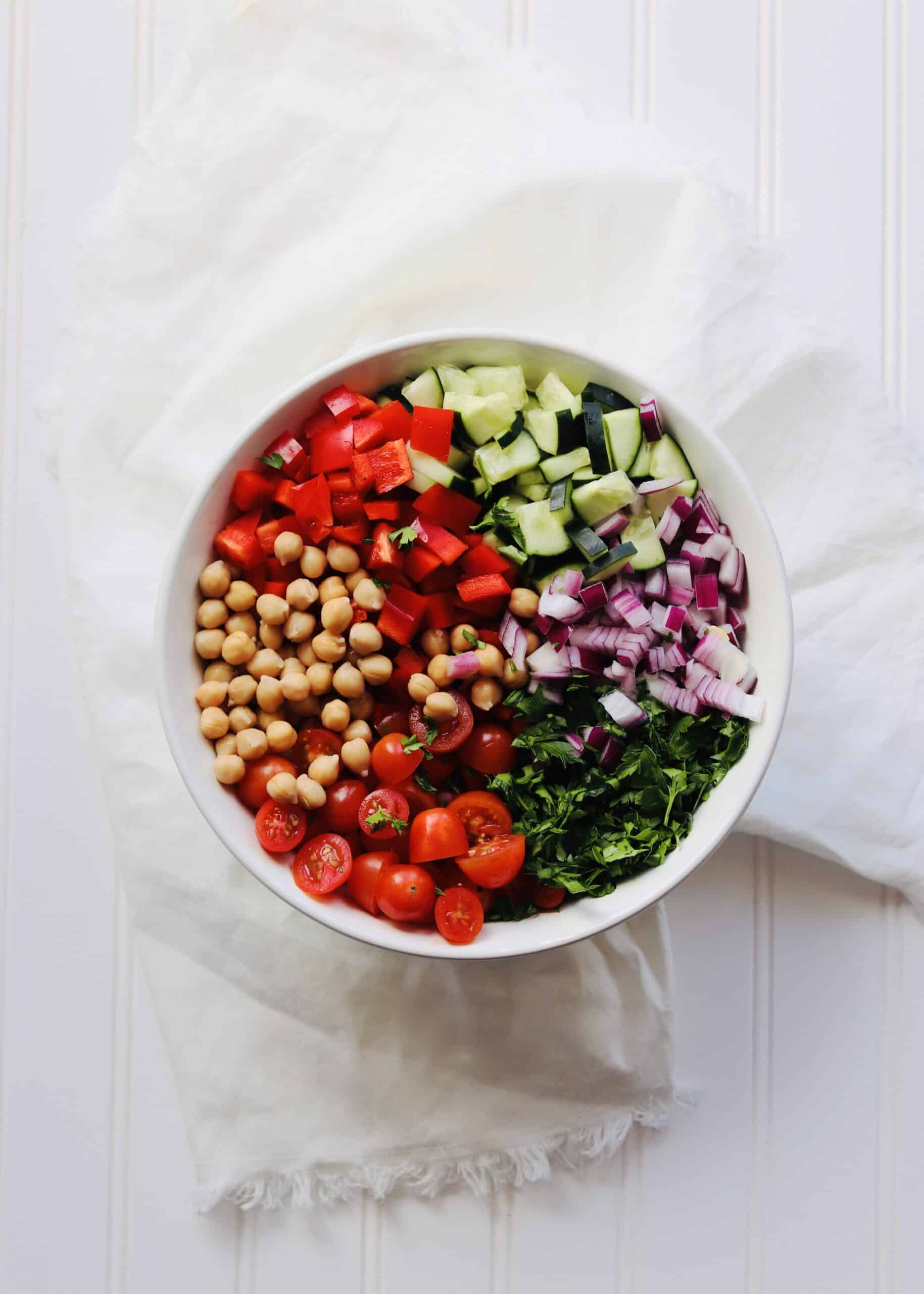 Greek Chickpea Salad is a perfect vegan side dish. No cooking, healthy, clean ingredients and keeps well in the fridge. Add this recipe to your meal prep rotation!