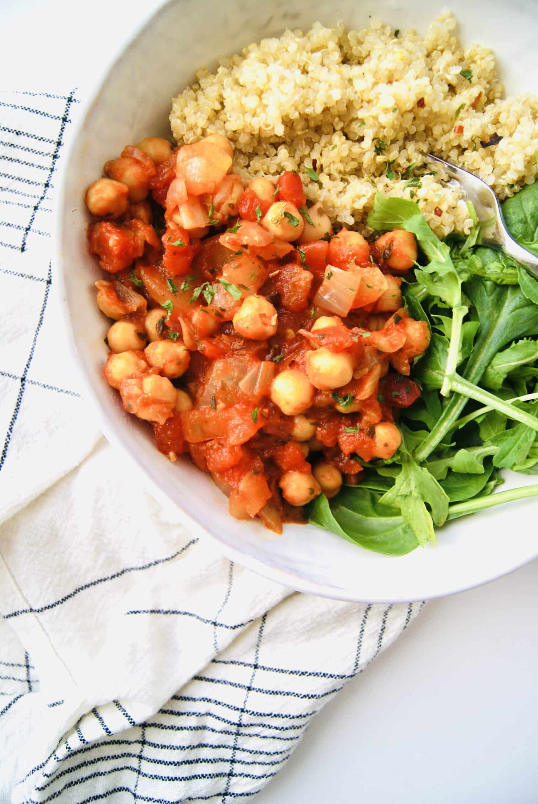 spicy chickpeas with quinoa and arugula in a bowl