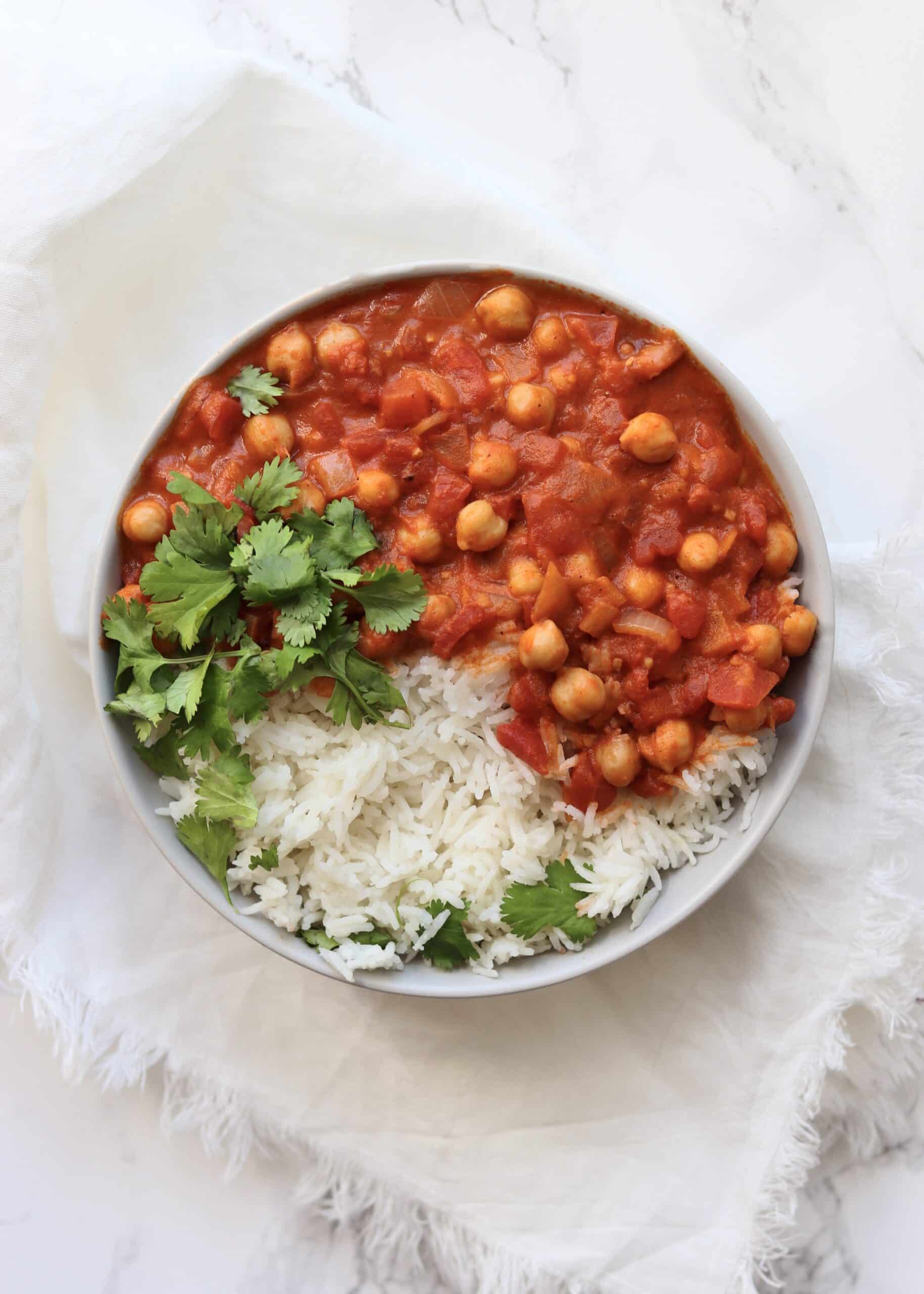 Vegan Chickpea Tikka Masala is perfect for meatless Monday or for healthy vegan meal prep for the week. Using pantry staple ingredients like canned coconut milk to make it creamy but dairy-free.