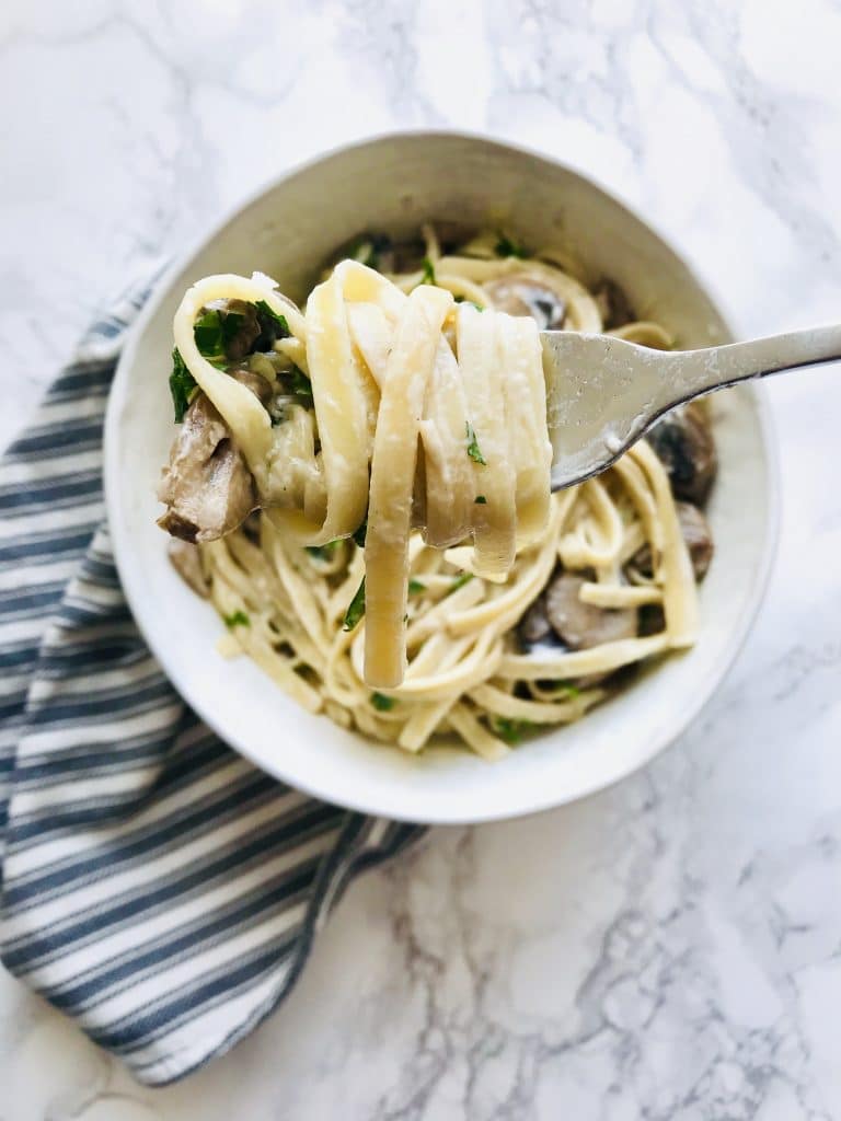 Mushroom Fettuccine is rich and decadent enough to make on a Saturday night alongside a bottle of wine. But easy enough with just a few ingredients to make on a weeknight. Lots of butter, cream, parmesan, and mushrooms. What's not to love? Recipe at KathleensCravings.com #creamypasta #mushroompasta