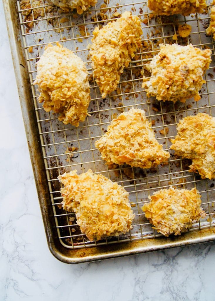Cornflake breaded baked chicken on a baking sheet