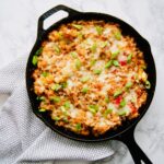 This Quinoa Chicken Fajita Bake is going to be your new fave weeknight dinner recipe. Full of tons of fajita flavor and veggies, quinoa, salsa, and cheese... all cooked up in your cast iron skillet. Recipe at KathleensCravings.com #chickenfajitas #castironskillet #chickenquinoabake #chickenbake #skilletbake