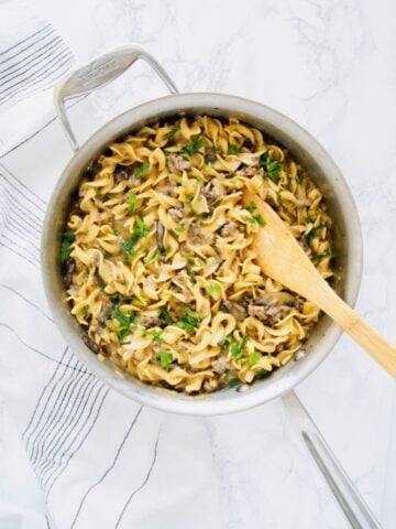 Everyone's favorite, comforting Beef Stroganoff but conveniently made in one-pot and using ground beef to cut down on costs. It's lightened up by using greek yogurt instead of sour cream. But you won't even notice! Perfect weeknight dinner that is ready in just 30 minutes. Recipe at KathleensCravings.com #KathleensCravings #onepotmeal #onepotrecipe #groundbeefrecipe #groundbeef #lightenedup