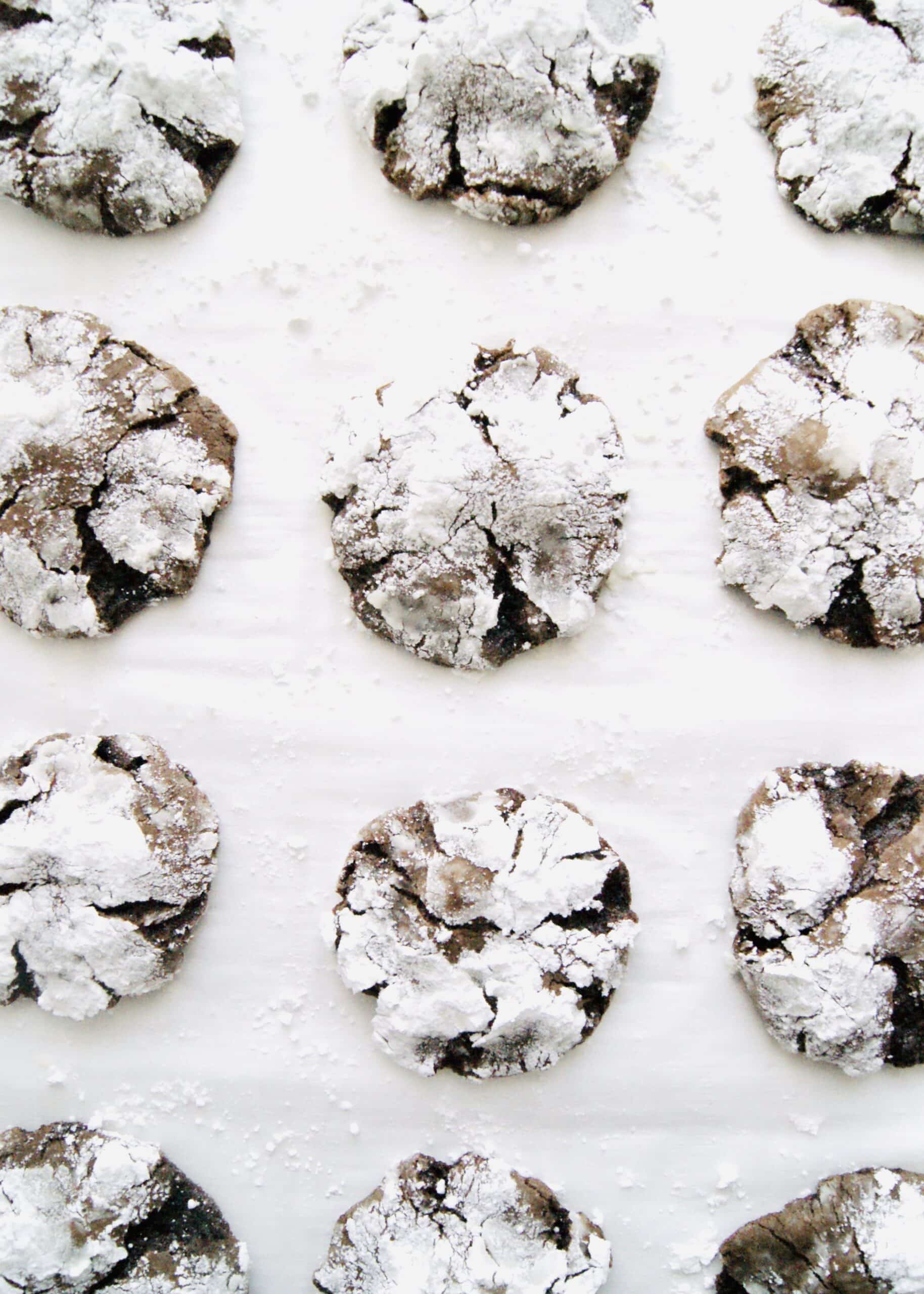 Chocolate Crinkle Cookies are a traditional Christmas Cookie and always a crowd favorite. These chocolate cookies are thick, soft, and resemble a brownie in a cookie! Recipe at KathleensCravings.com #kathleenscravings #christmascookies #holidaycookies #chocolatecookies #crinklecookies