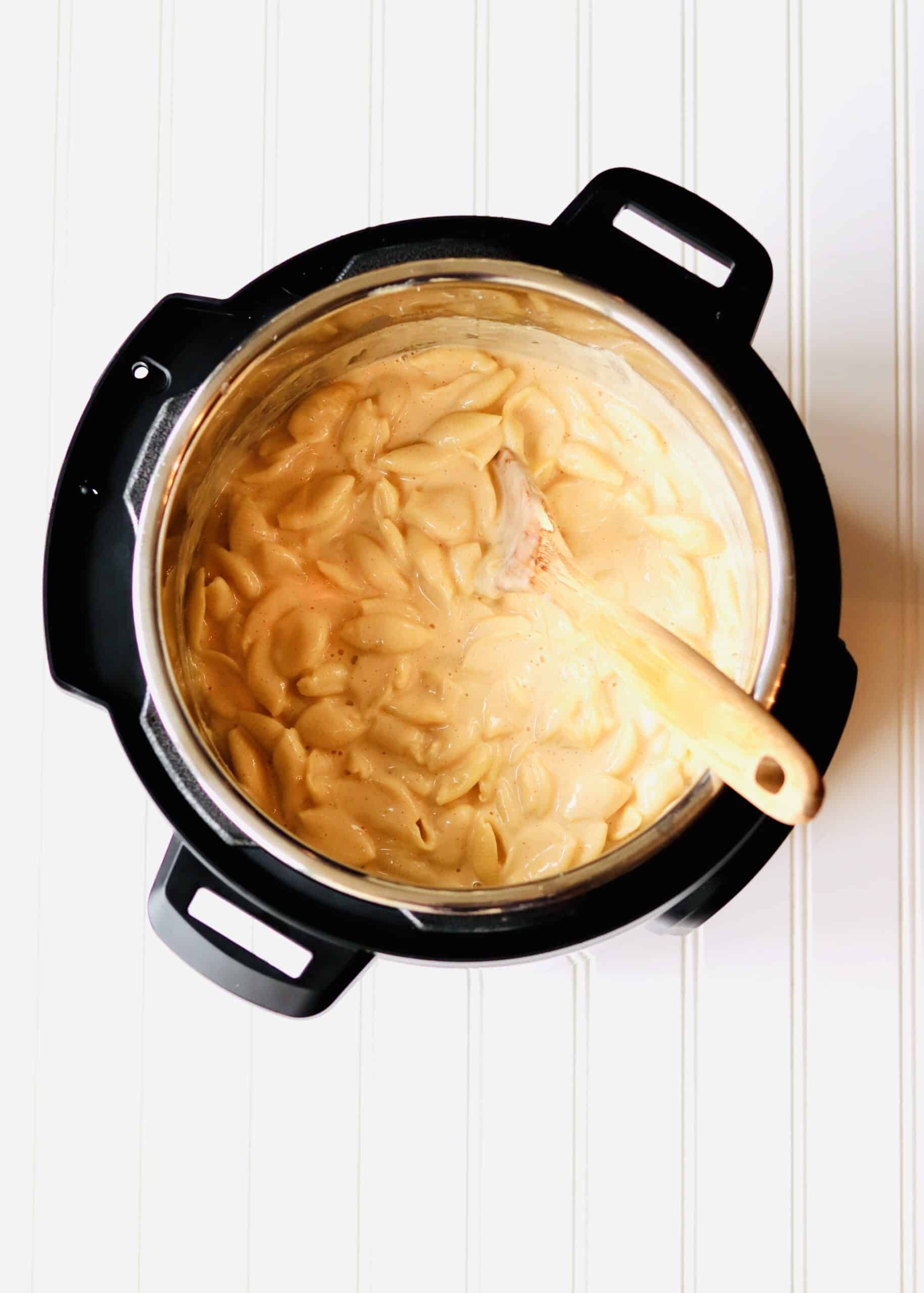 Instant Pot Mac and Cheese is the perfect comfort food. Uses just 4 ingredients (plus a few basic spices) and comes together in less than 30 minutes. Using evaporated milk makes this pasta extra rich and creamy. Recipe at KathleensCravings.com