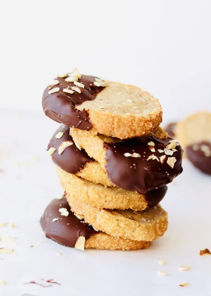chocolate dipped brown butter almond shortbread cookies stacked