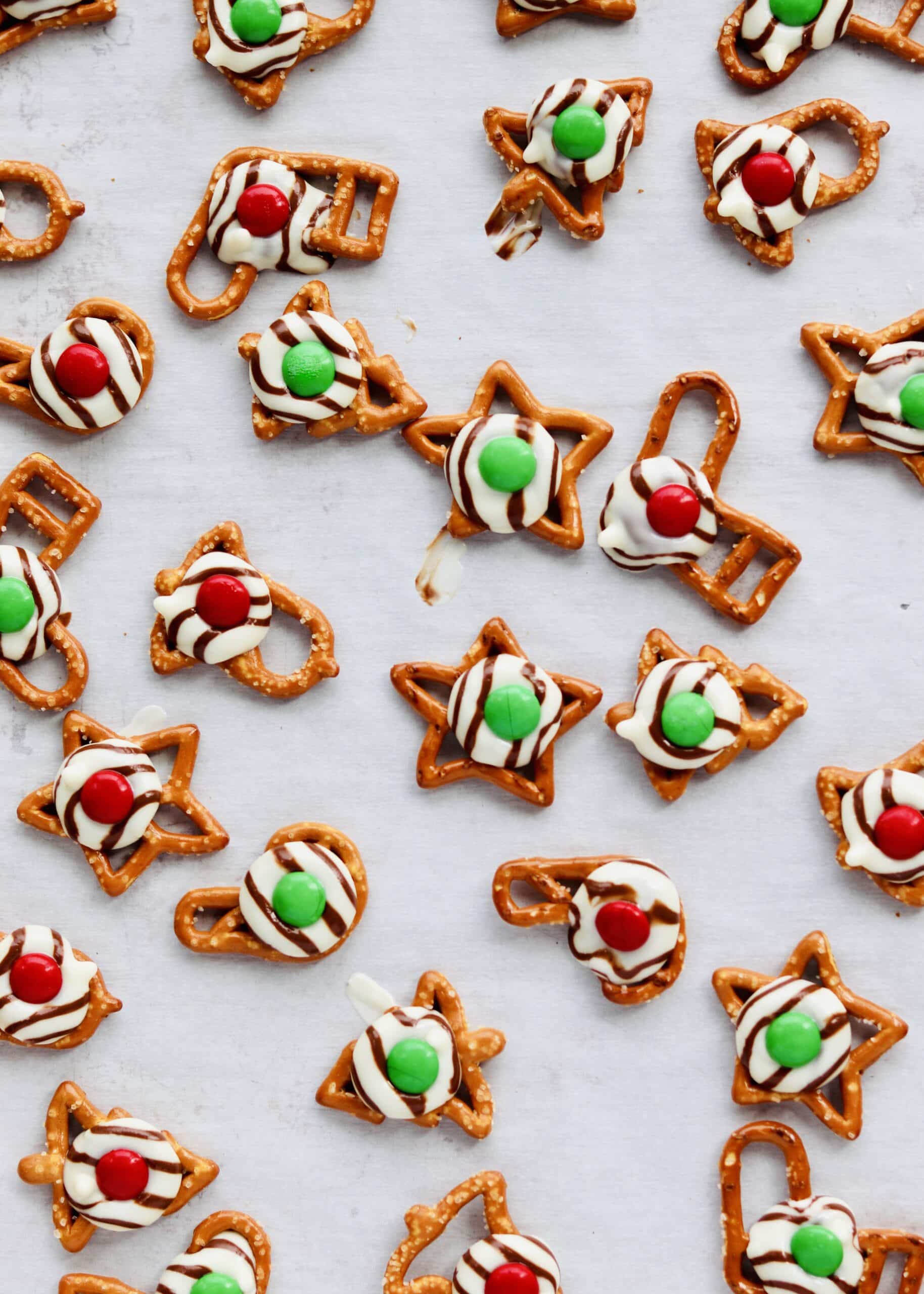 Christmas Pretzel Hugs are the perfect combination of salty and sweet. Easily made with just 3 ingredients and perfect to make ahead for some holiday prep. Recipe at KathleensCravings.com #kathleenscravings #pretzeltreats #pretzelhugs #christmascookies #holidaycookies #hersheyskisses