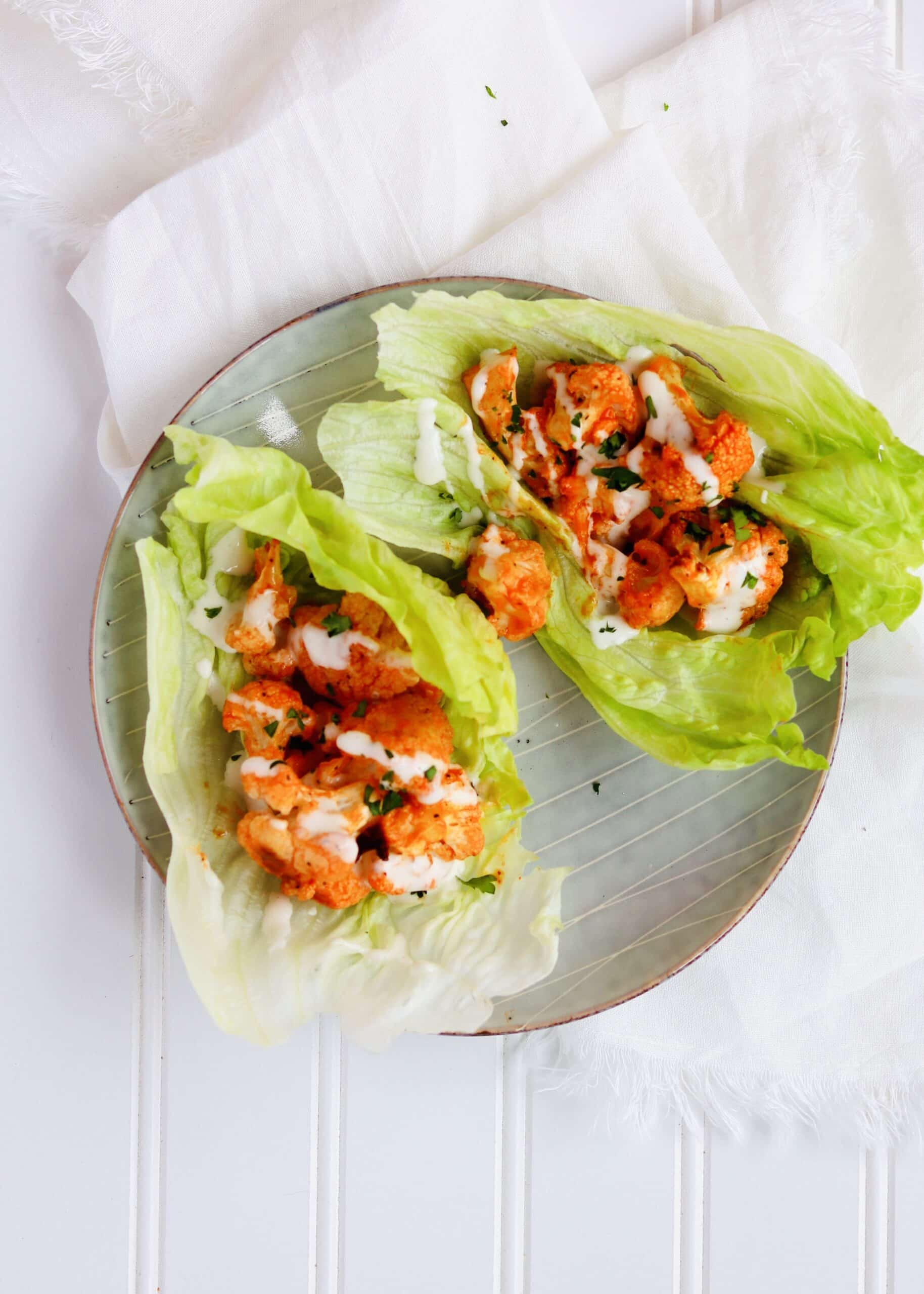 Buffalo Cauliflower Lettuce wraps are so simple and easy to make. Perfect for satisfying your buffalo craving in a healthy, plant-based, meatless way. Perfect as an appetizer or as part of a Meatless Monday dinner. Recipe at KathleensCravings.com #kathleenscravings #meatlessmonday #plantbased #cleaneating #vegetarianappetizer #buffalolettucewraps #cauliflowerrecipes