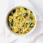 One Pot Spinach Artichoke Pesto Pasta is comforting, cozy, and perfect for meatless Monday. This vegetarian dish is made in one dutch oven, so clean up is easy. Recipe at KathleensCravings.com #kathleenscravings #meatlessmonday #vegetarian #plantbased #onepotpasta #pestopasta #spinachartichoke