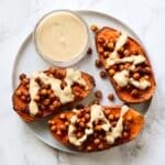 Sheet Pan Chickpea Loaded Sweet Potatoes are the perfect easy vegan dinner. All roasted on one sheet pan reduces clean up. Using just basic pantry staple ingredients to make this healthy, meatless meal.