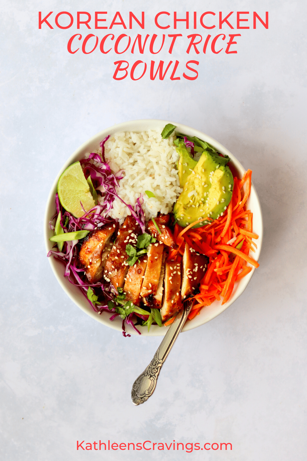 Korean chicken rice bowl with chicken thigh, carrots, cabbage, avocado, and a lime wedge.