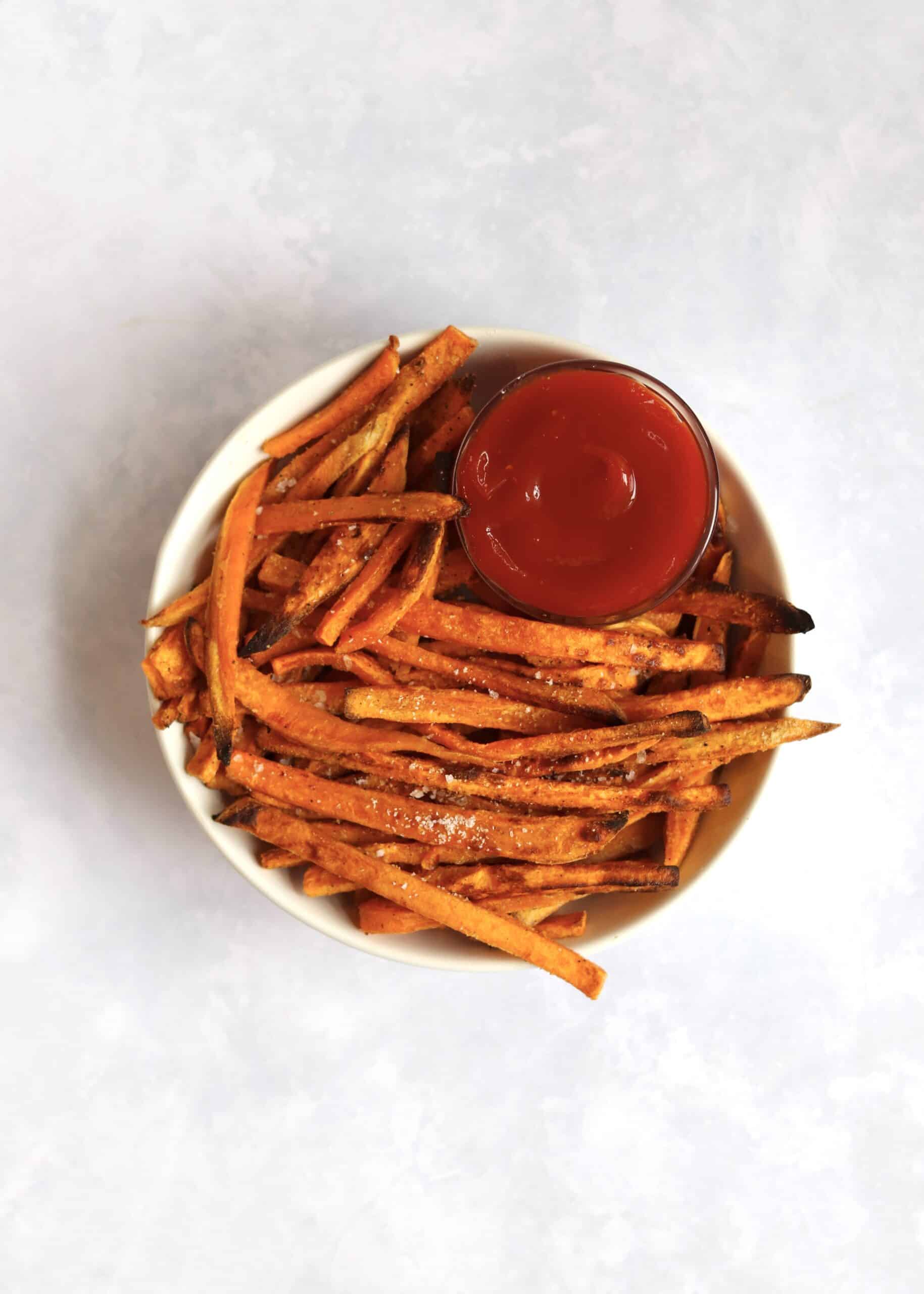 Bowl of sweet potato fries with ketchup