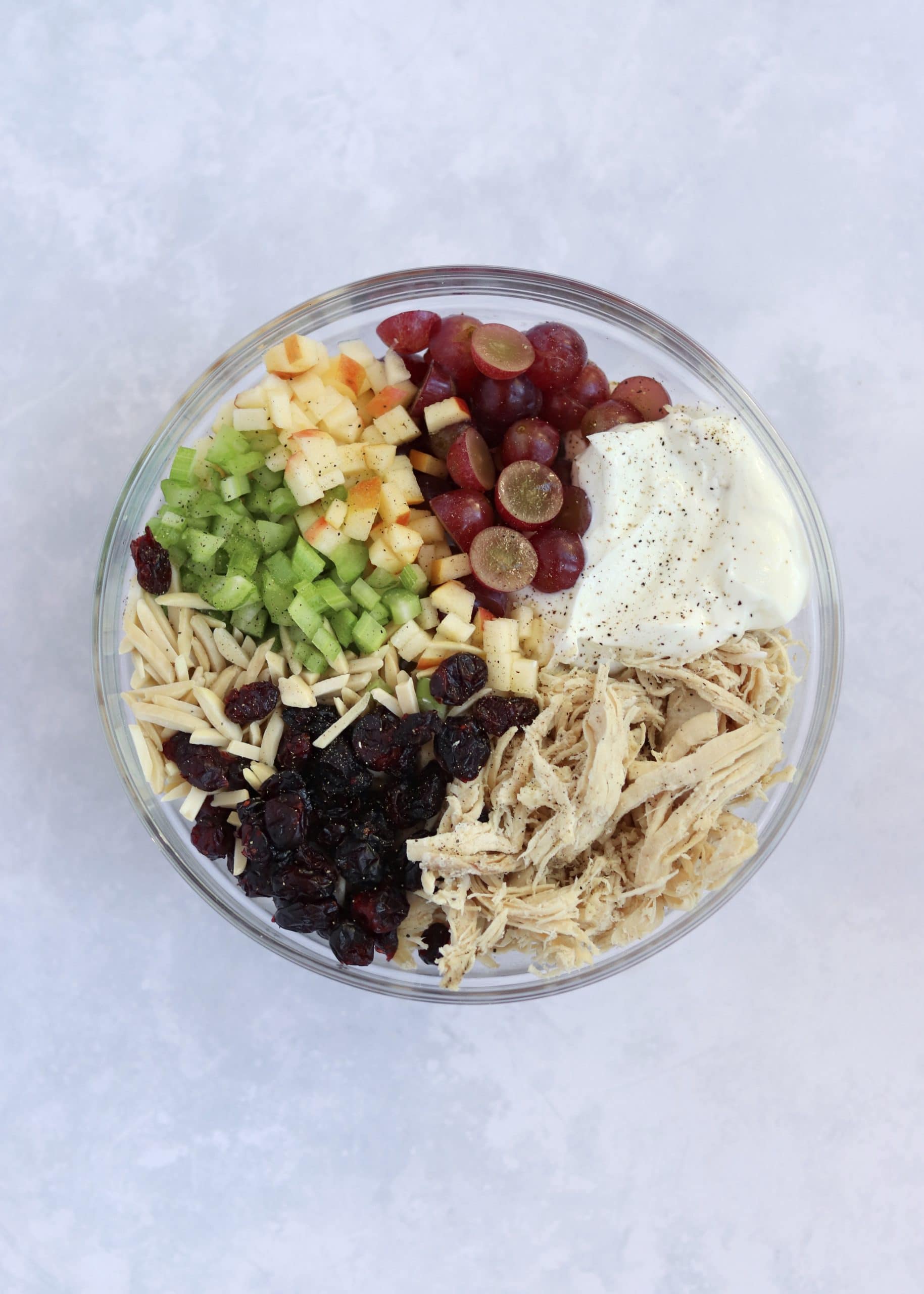 Chicken salad ingredients in glass bowl