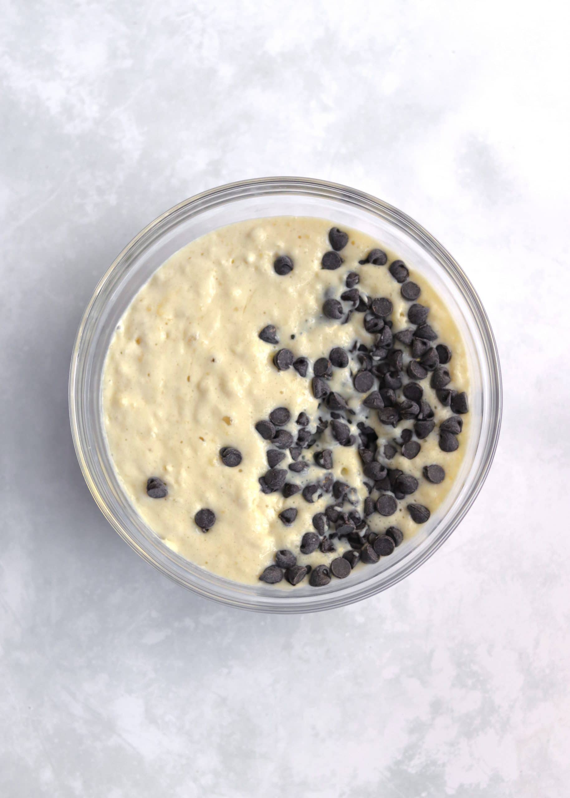 Chocolate chip pancake batter in a glass bowl