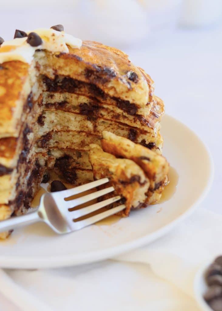 Fork with a cut piece of chocolate chip pancakes