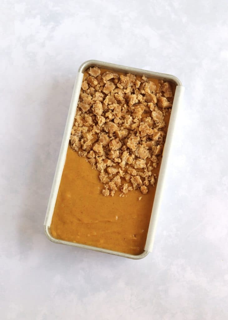 Unbaked pumpkin bread with streusel topping in loaf pan