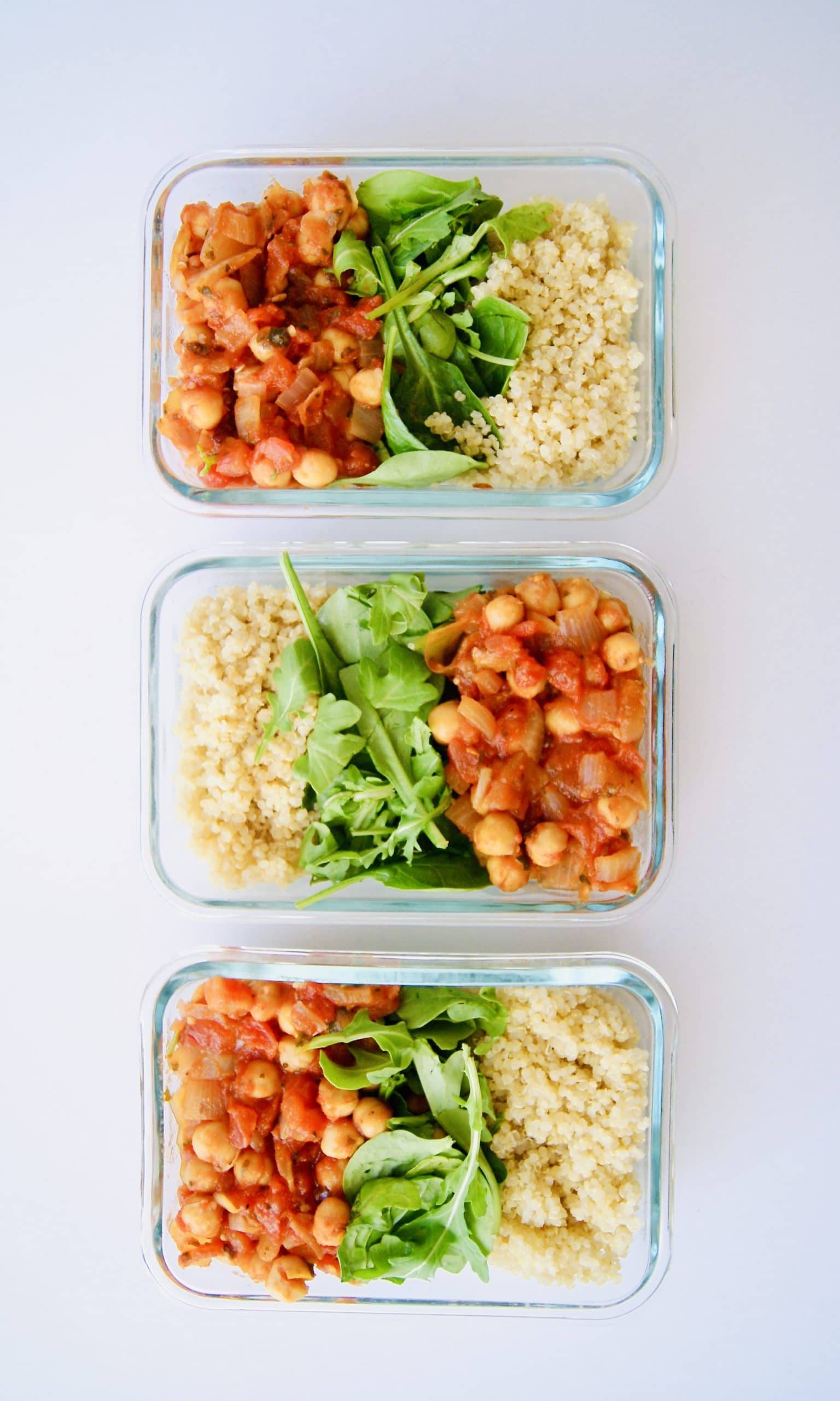 Meal prep containers with vegan tomato chickpeas and quinoa