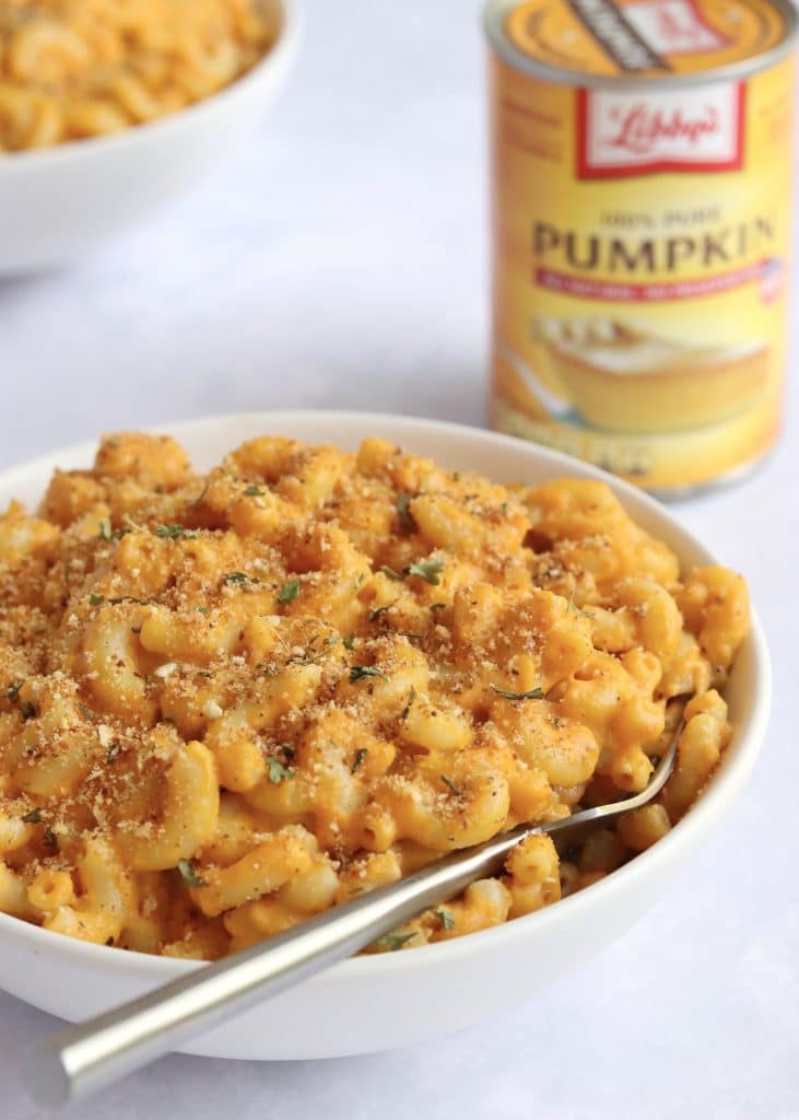 Bowl of pumpkin Mac and cheese with can of Libbys pumpkin puree