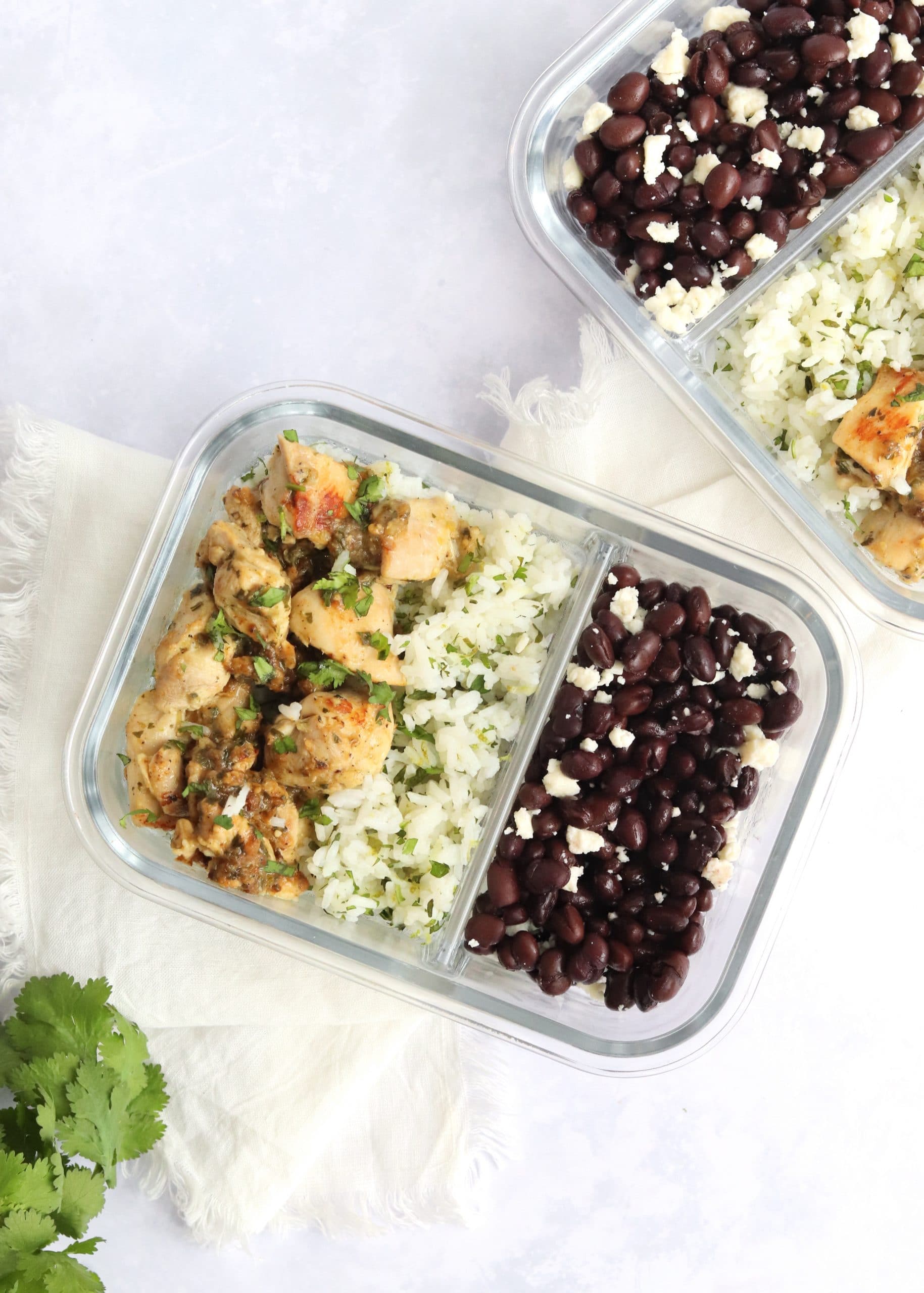 Salsa verde chicken meal prep containers with fresh cilantro