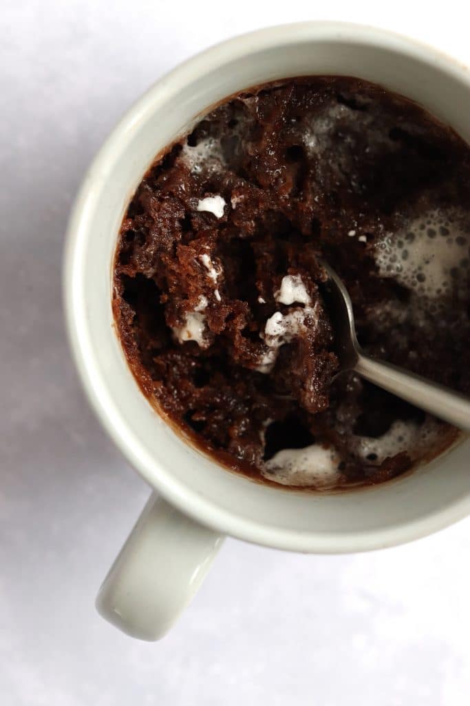 Hot cocoa mug cake made in the microwave with gooey marshmallows on top
