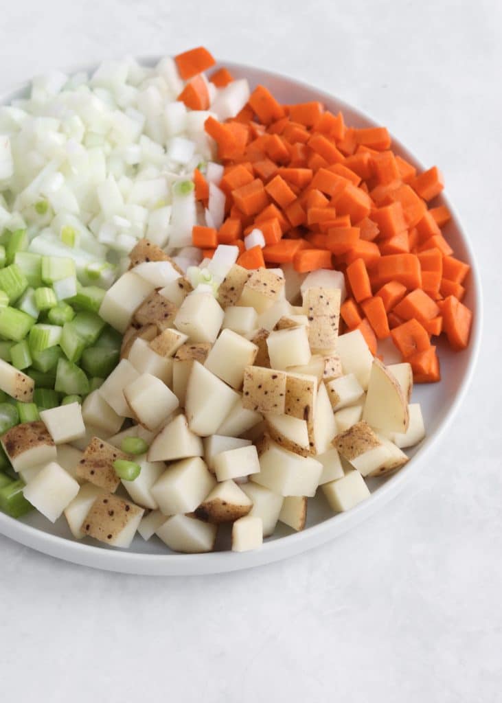 Plate of diced carrot, celery, onion, and potato