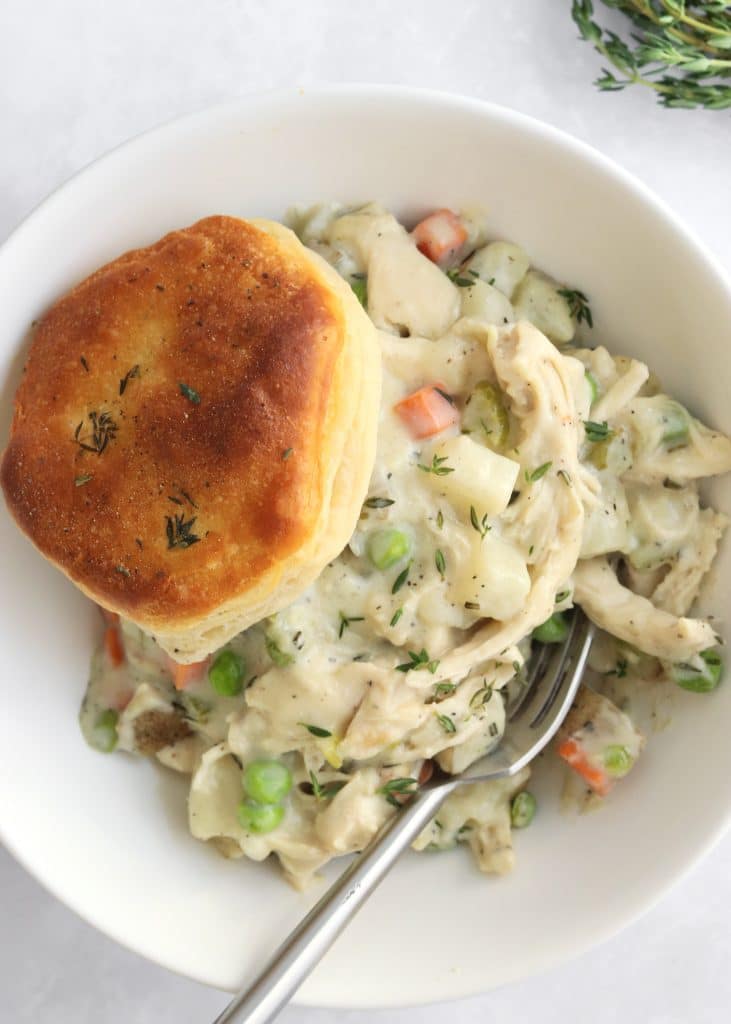 Bowl of leftover turkey pot pie with a biscuit