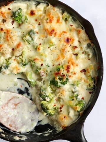 cheesy baked broccoli gnocchi in a cast iron skillet