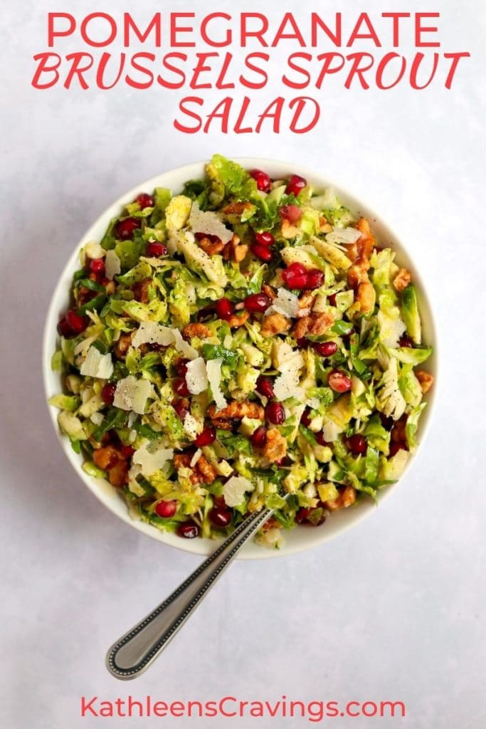 Bowl of Shredded Brussels sprout salad with pomegranates and walnuts