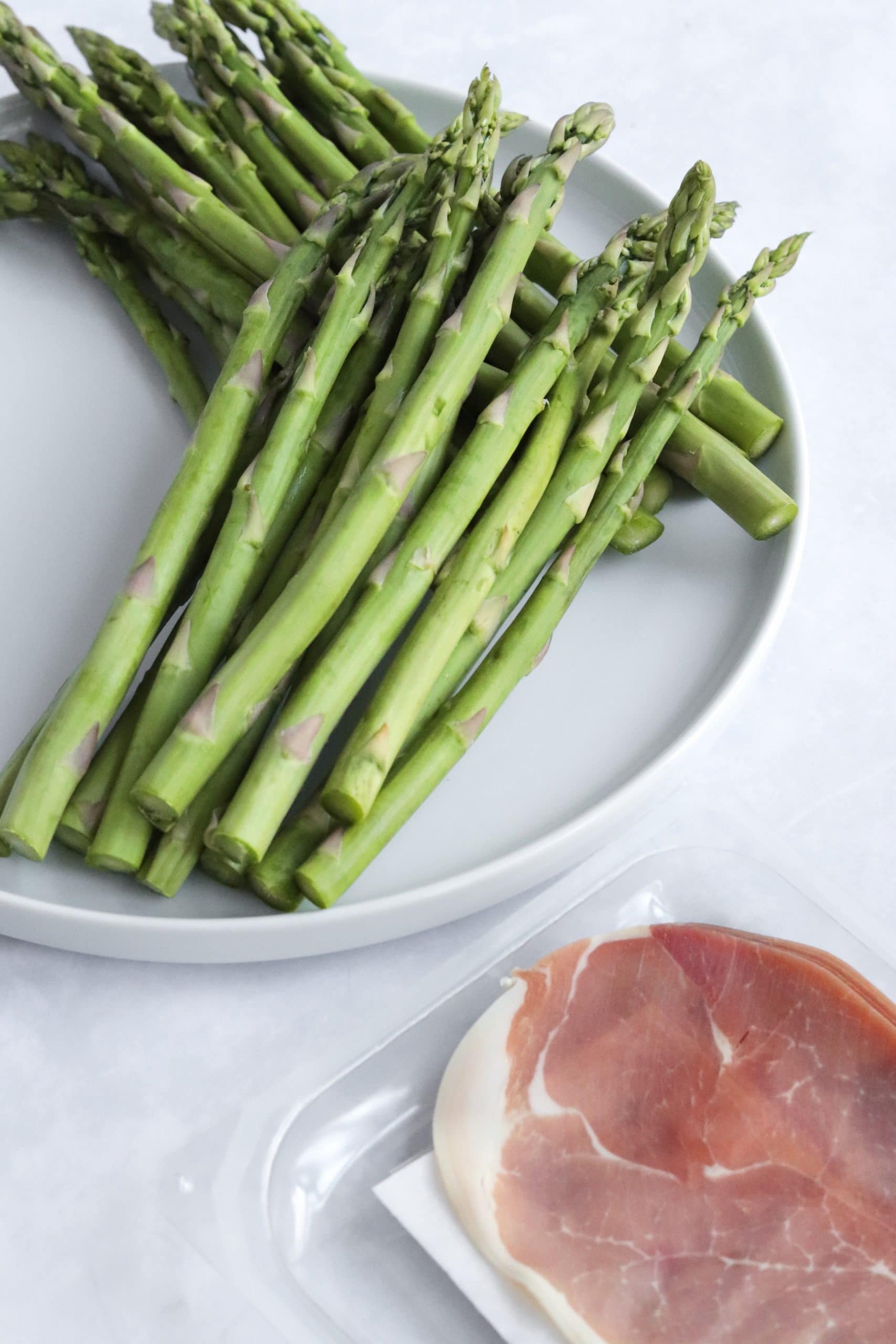 Raw asparagus and prosciutto slices