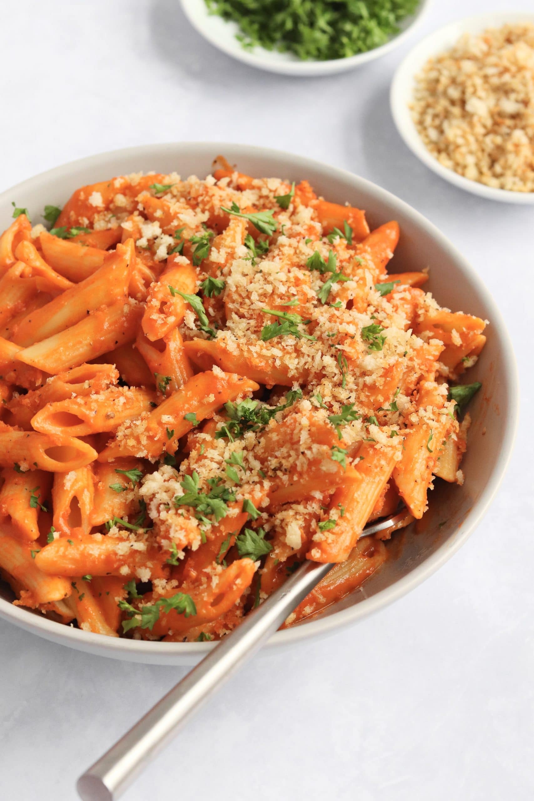 Tomato pasta made with coconut milk and topped with breadcrumbs.