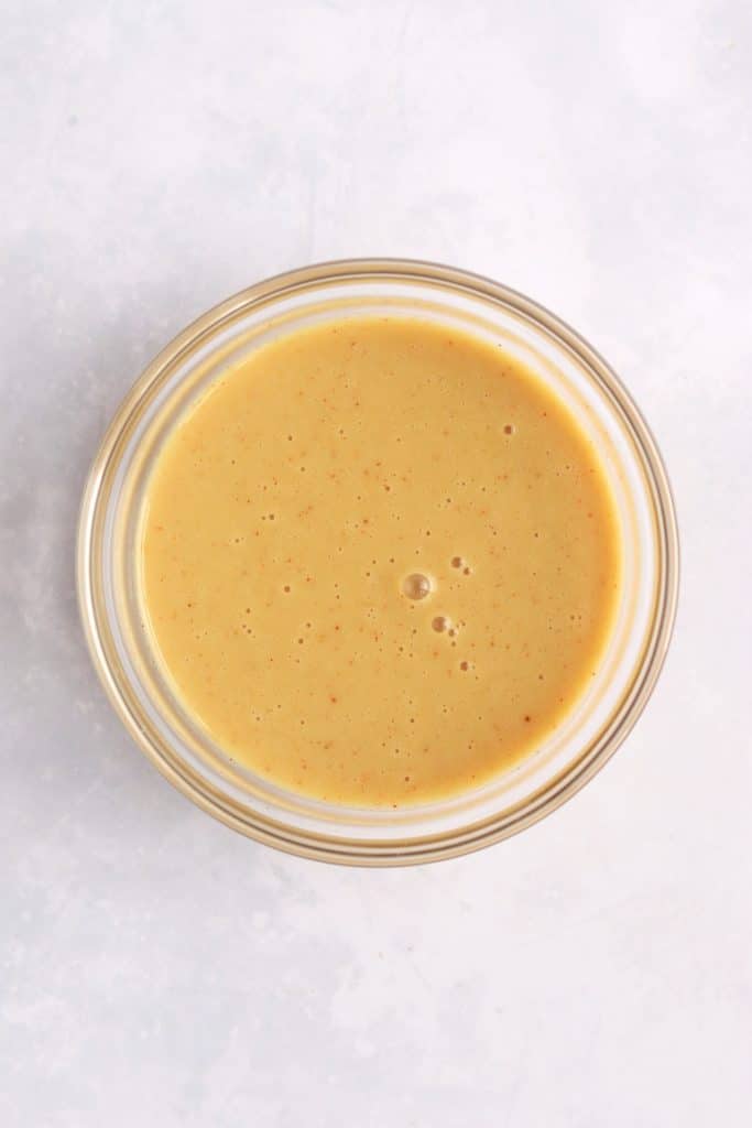 Glass bowl of honey mustard dipping sauce