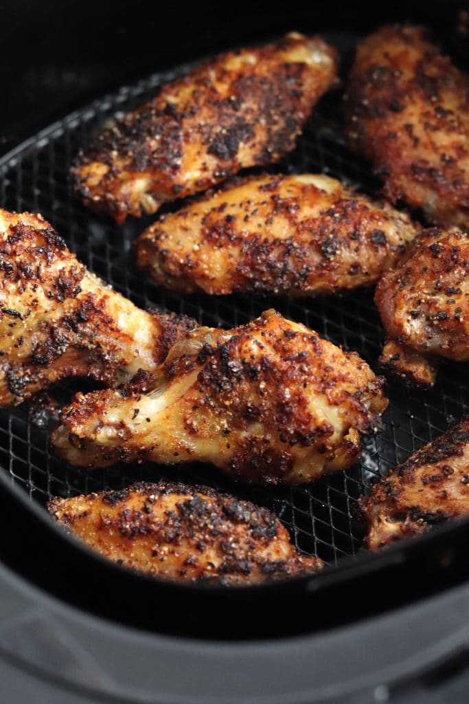 Close up of dry rub crispy chicken wings in an air fryer
