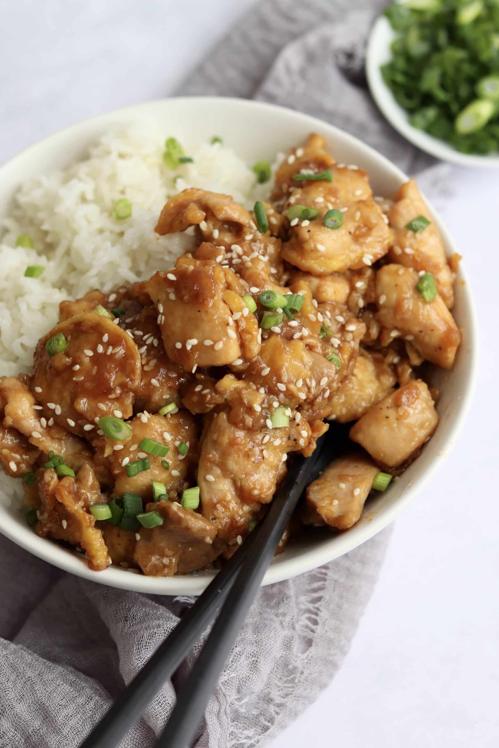 Sesame chicken with white rice in a bowl