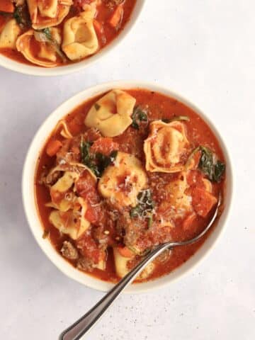 Two bowls of slow cooker sausage tortellini soup