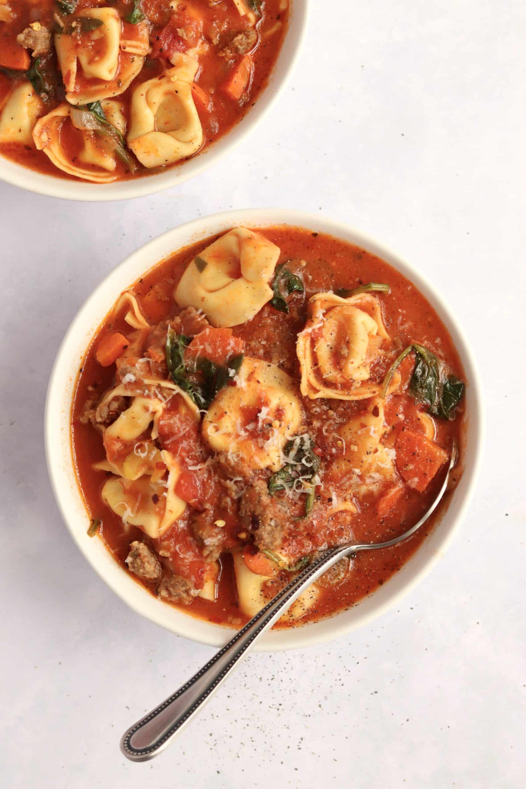 Two bowls of slow cooker sausage tortellini soup