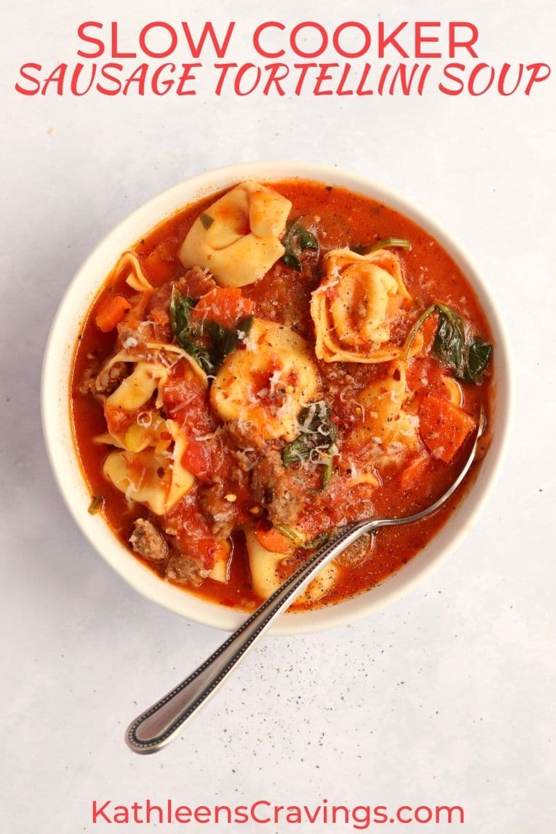 Creamy tomato sausage tortellini soup in a bowl with a spoon.