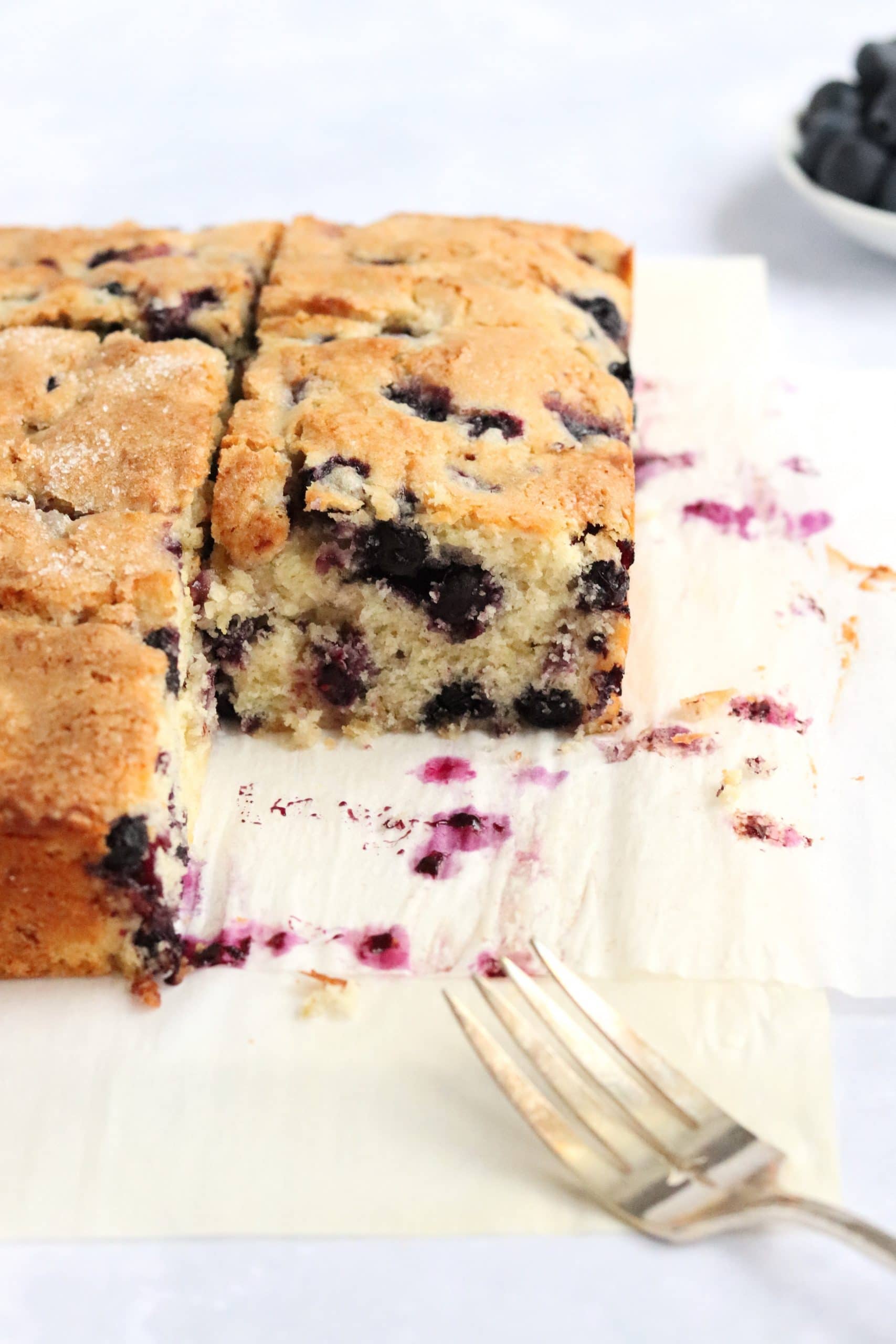 Slices of blueberry breakfast cake with a fork.