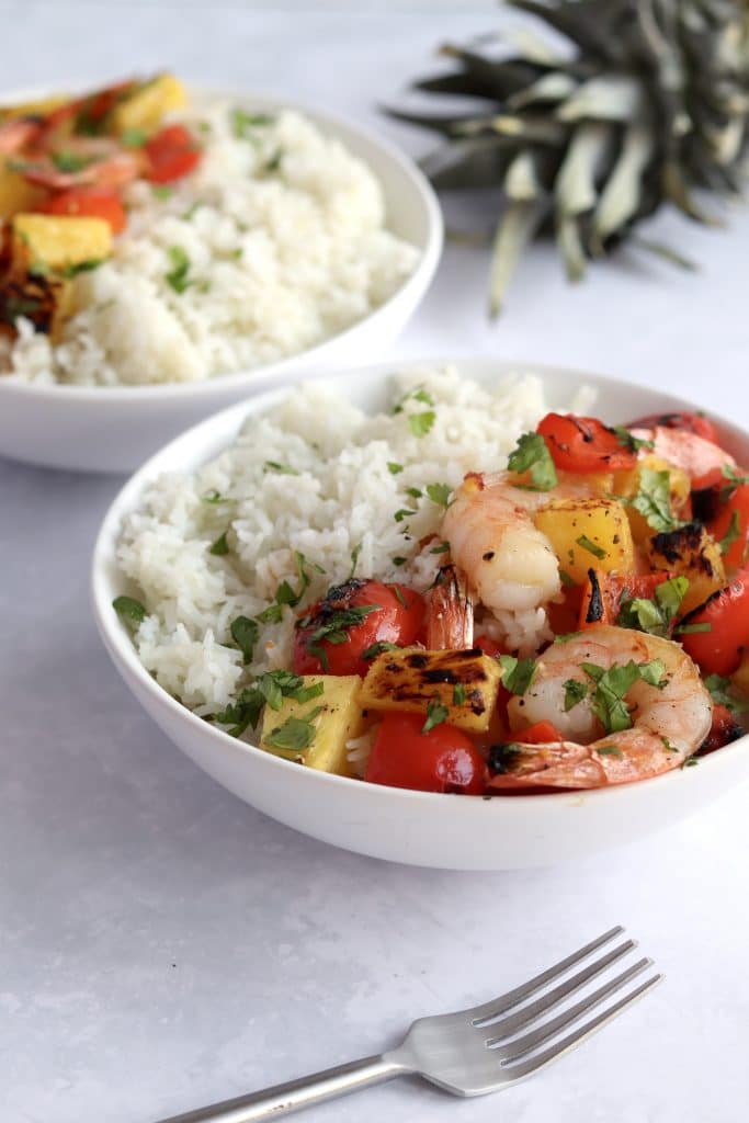 Two bowls of Hawaiian pineapple shrimp with white rice.