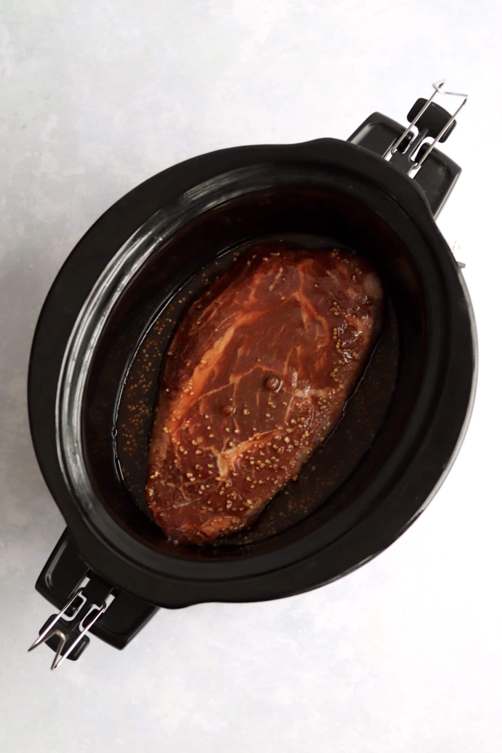 Chuck roast in a slow cooker with a Korean sauce.
