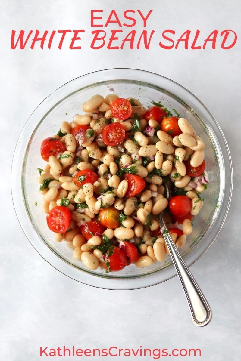 Bowl of white bean salad with tomatoes.
