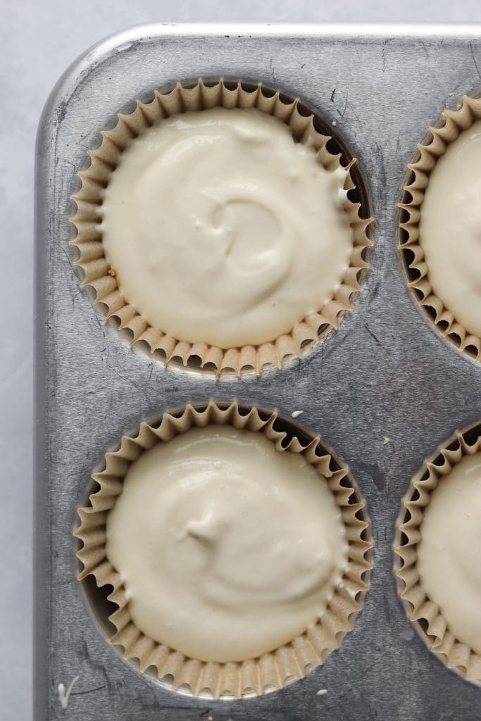 Unbaked mini cheesecakes in muffin tin