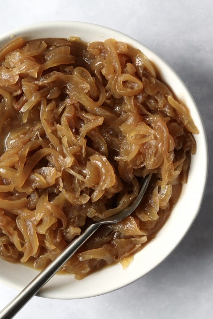 Caramelized onions in a bowl with a fork