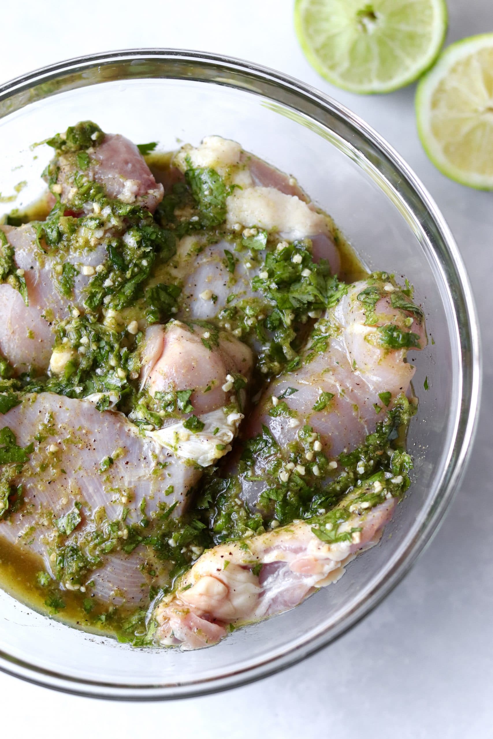 Boneless chicken thighs in a bowl with cilantro lime marinade
