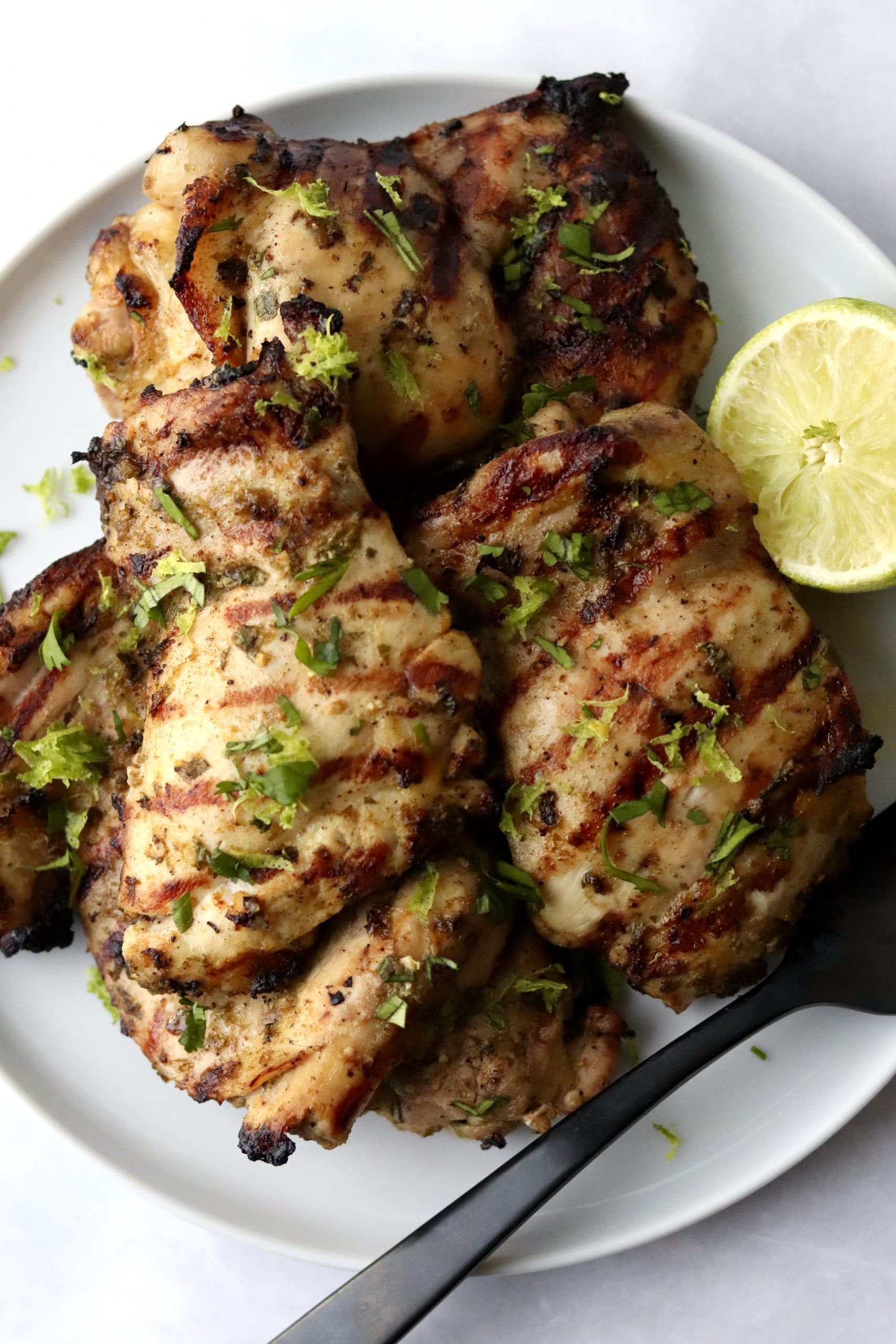 Grilled cilantro lime chicken thighs on a plate