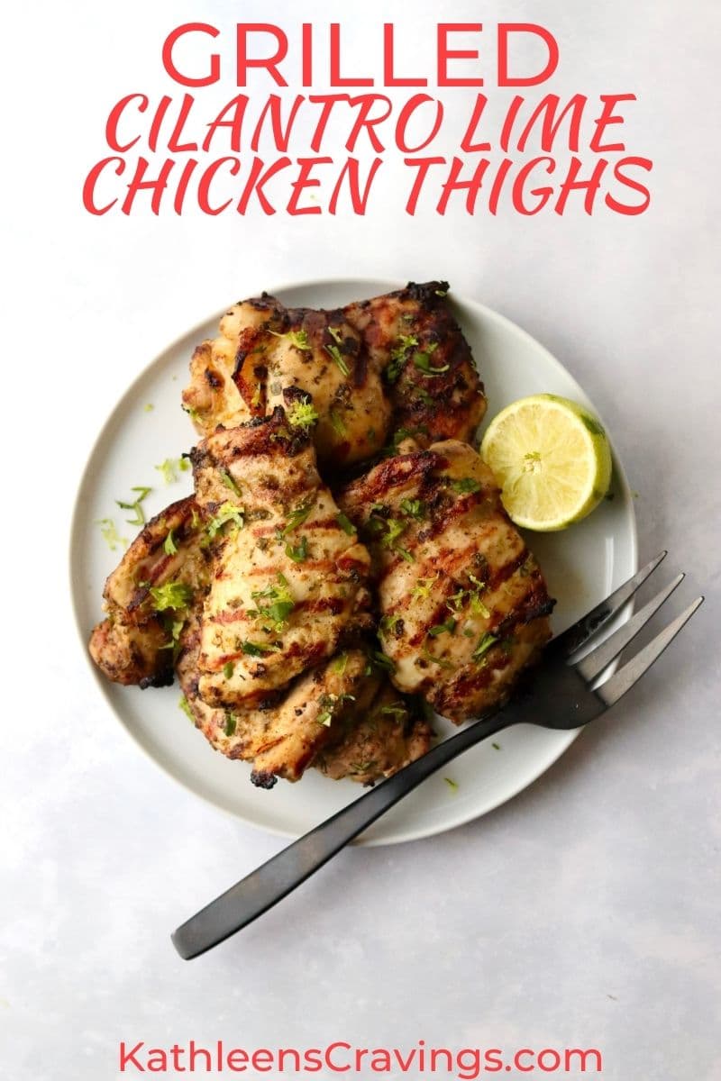 Grilled chicken thighs on a plate with lime