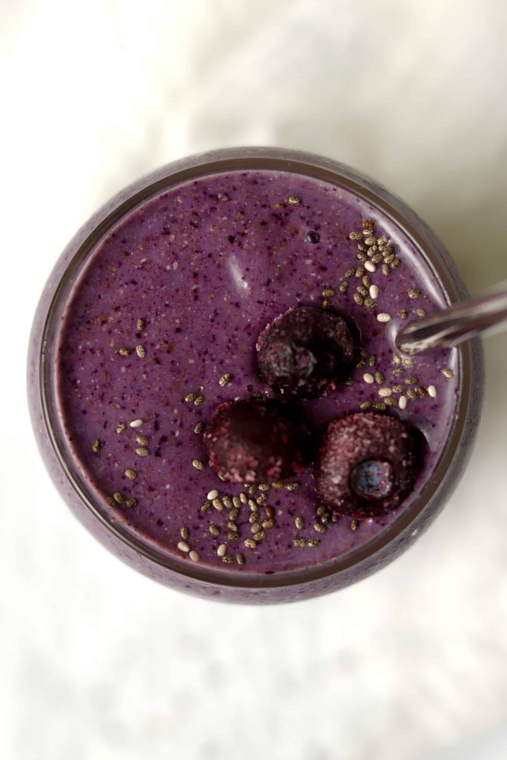 blueberry smoothie topped with frozen blueberries