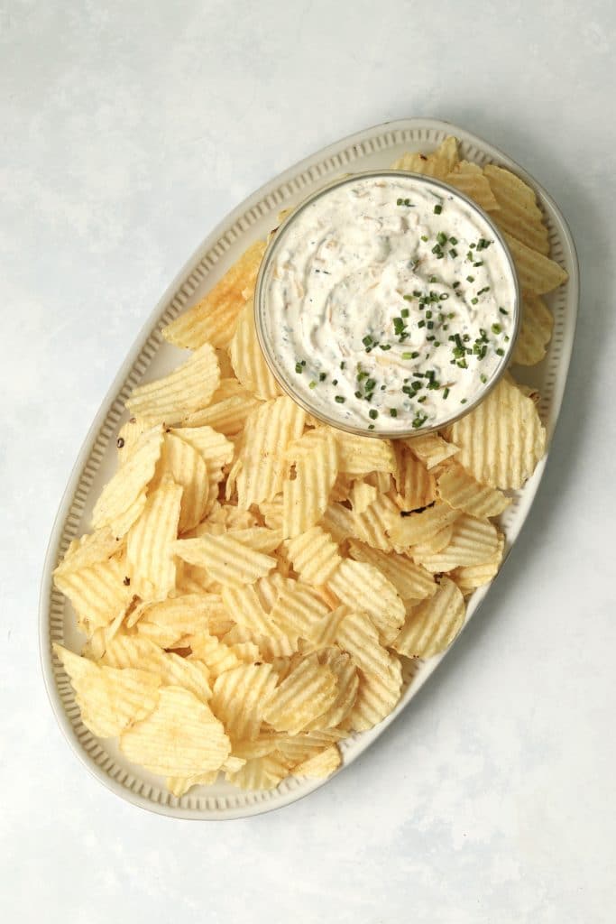 onion dip with chips on a platter