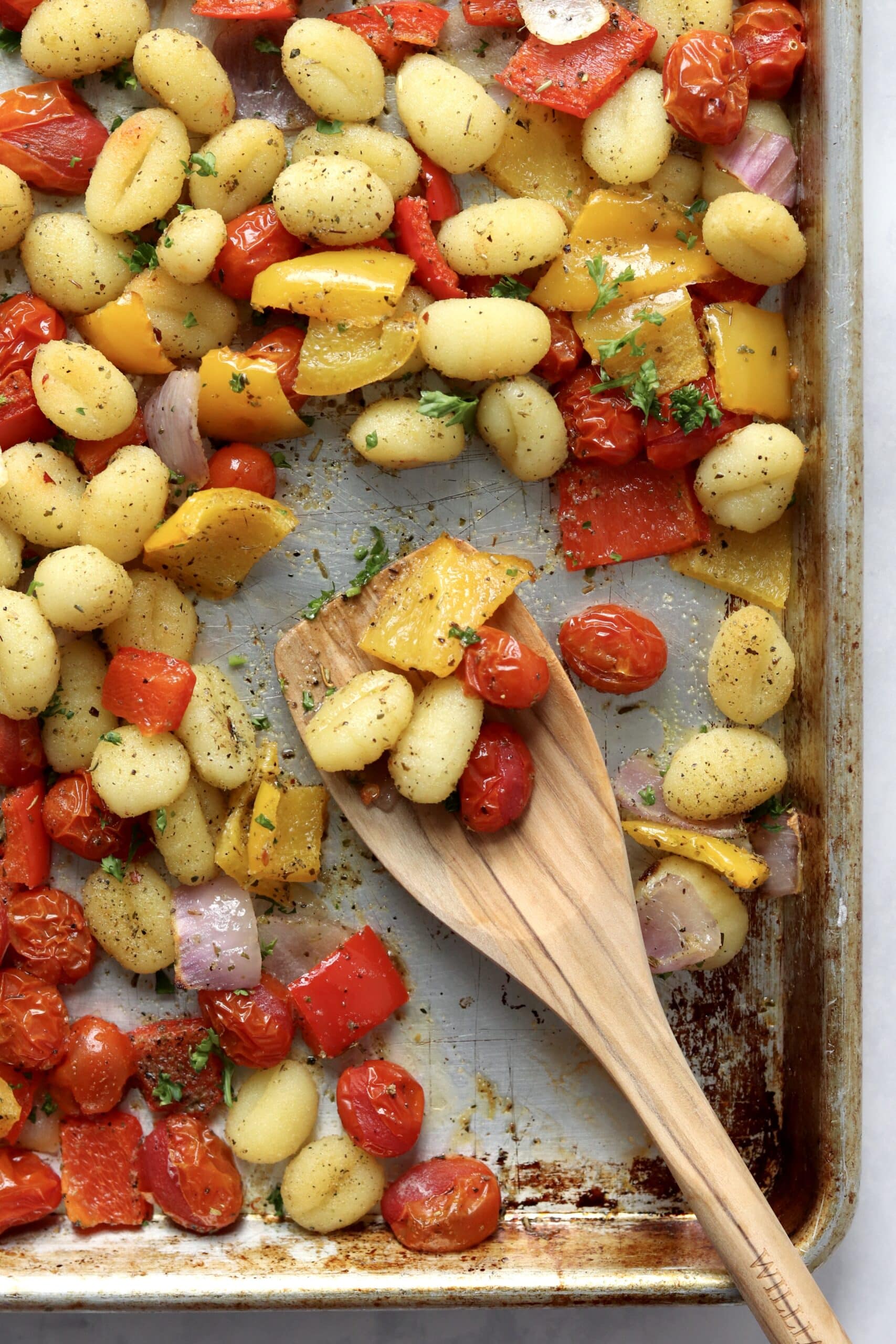 wooden spoon with roasted veggies and gnocchi