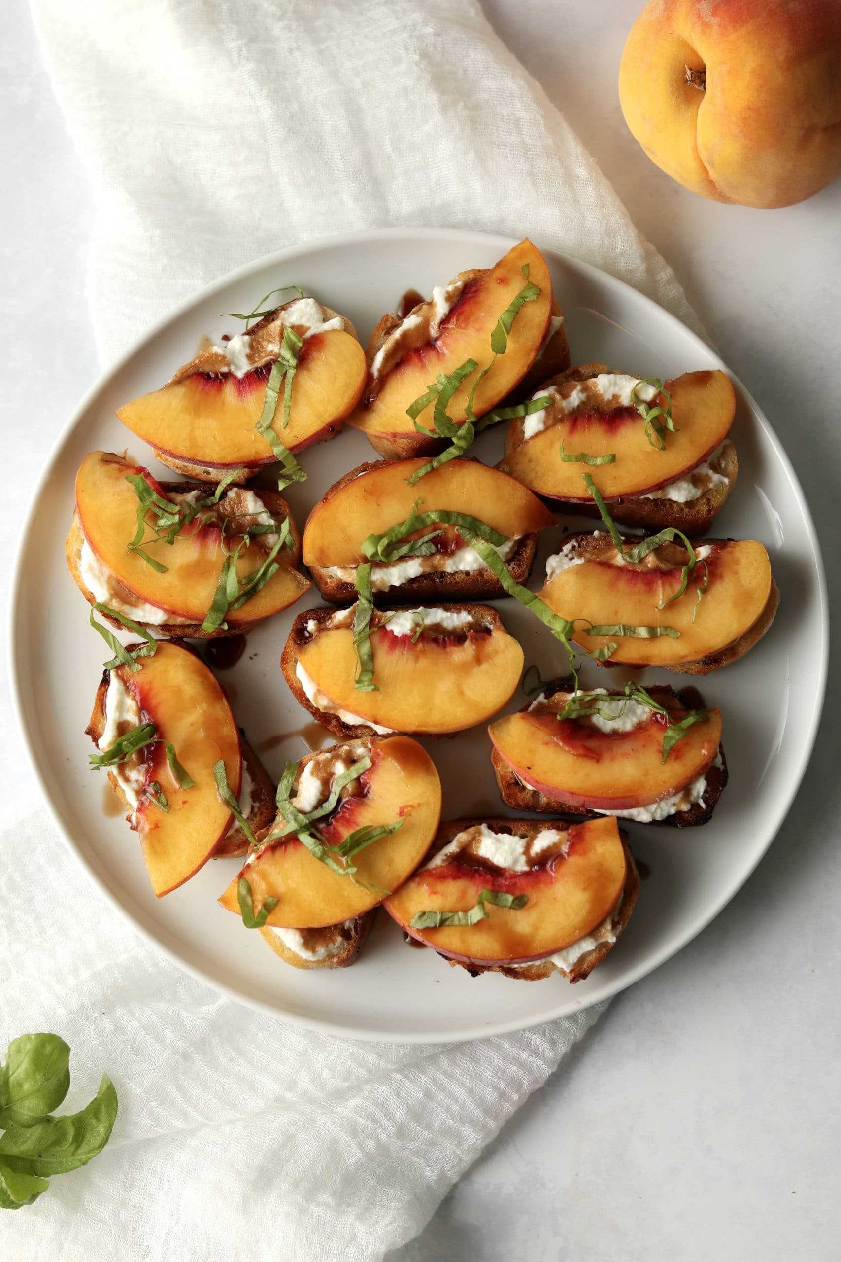 Plate of crostini with ricotta and peaches